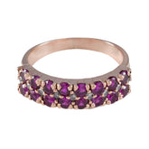 Lakshmi red gemstone engagement ring featuring double rows of deep red stones in rose gold setting